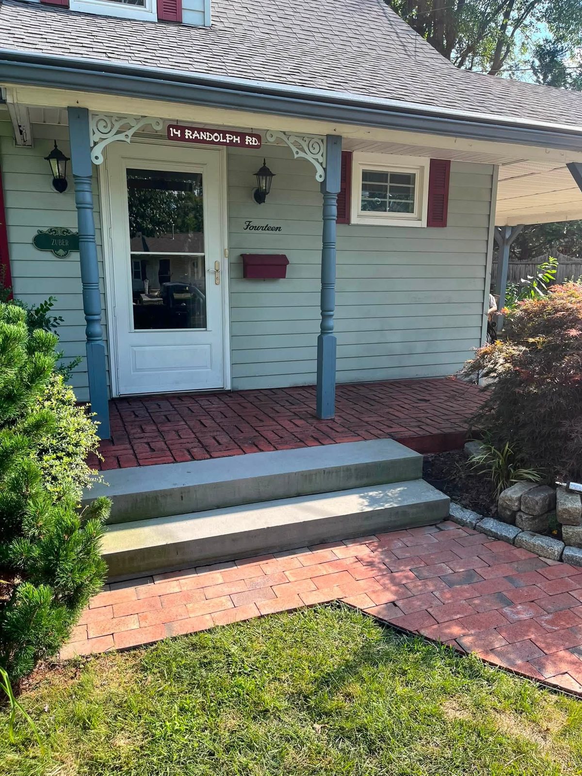 Front porch with red brick-pattern stamped concrete and new concrete steps